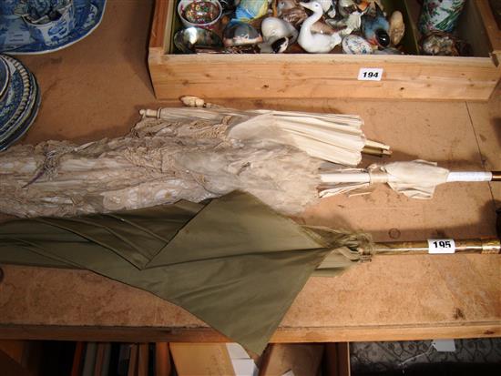 Cream silk parasole, parrot topped umbrella & lace umbrella